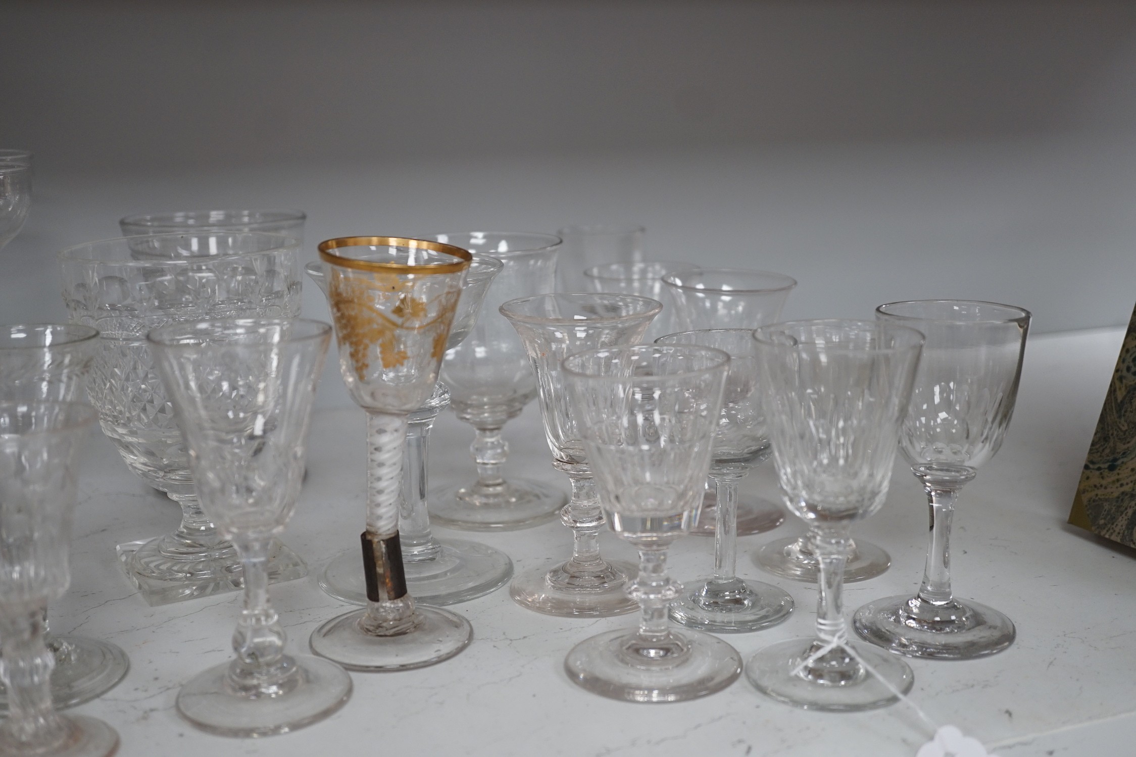 A quantity of assorted 18th / 19th century and later clear drinking glasses including a damaged James Giles gilt decorated opaque twist stem wine glass.